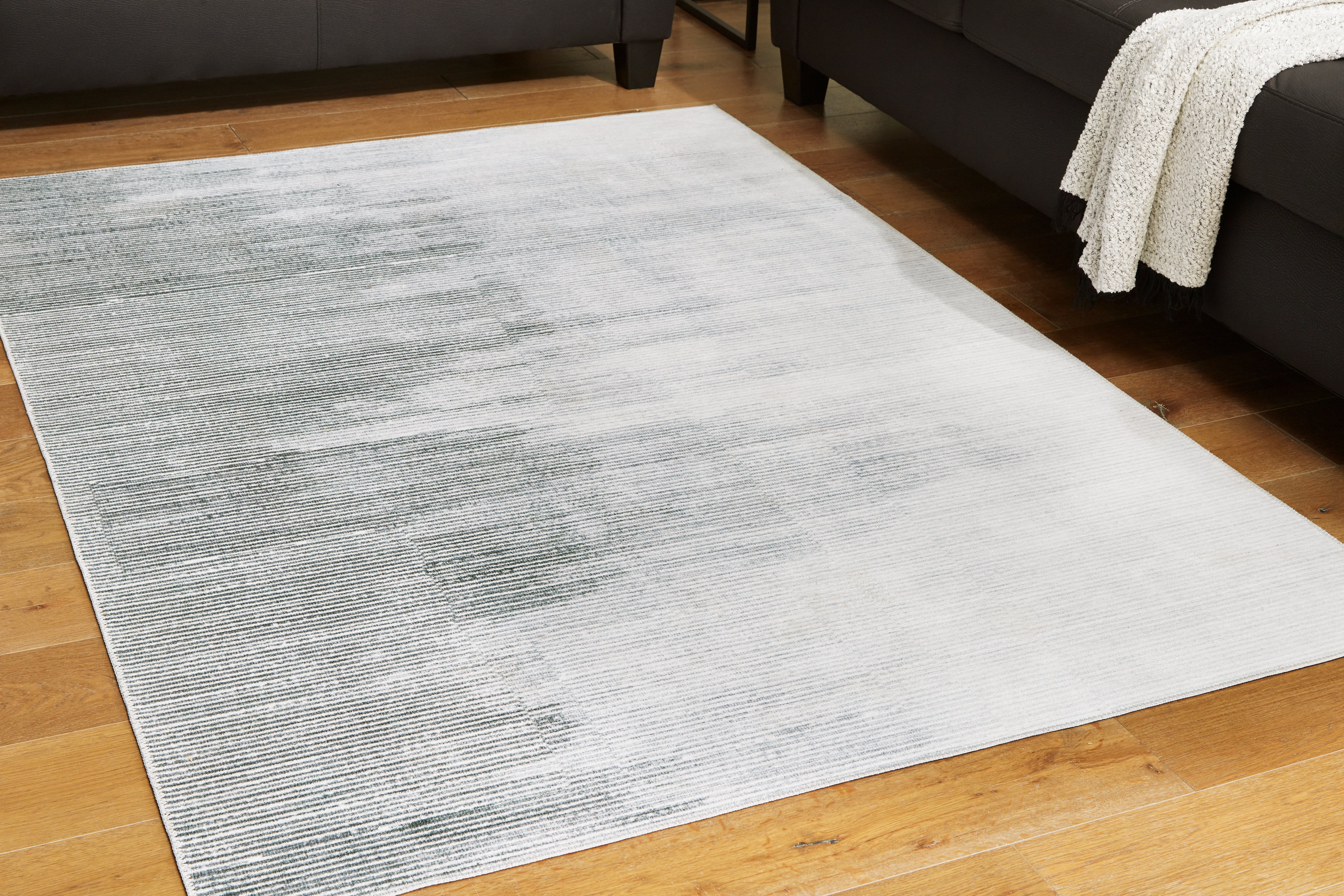 Fine Furniture & Decor - Ashley Furniture - Milset Rug - 5'1" x 6'10" Washable Rug / Black/White/Gray - R406252
