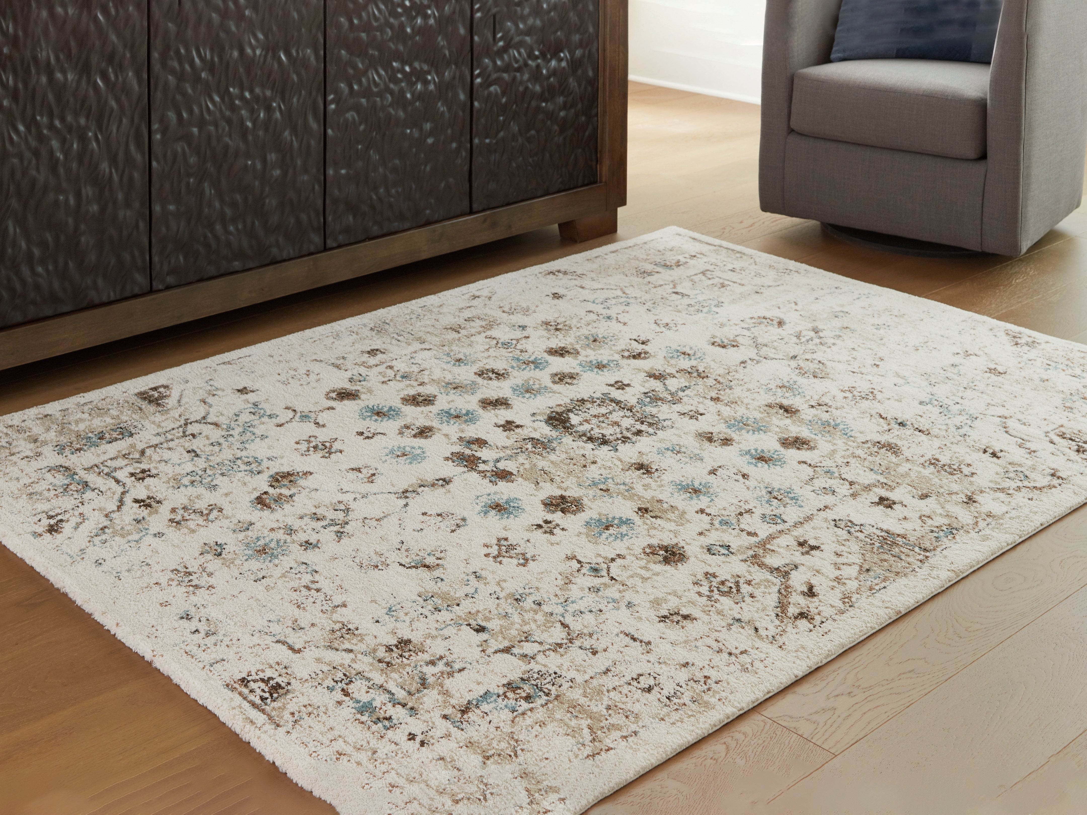 Fine Furniture & Decor - Ashley Furniture - Jossler Rug - 5' x 7' Rug / Ivory/Brown/Teal - R407072