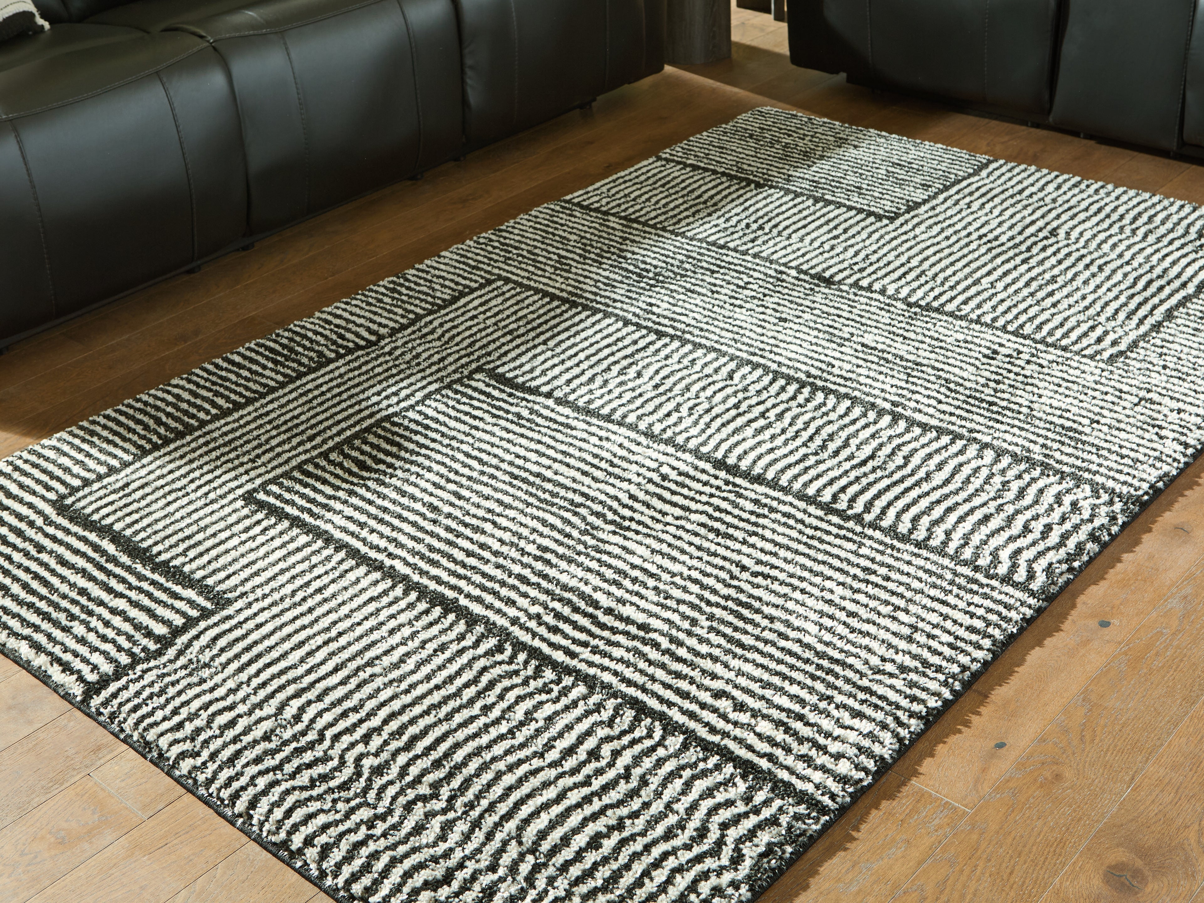 Fine Furniture & Decor - Ashley Furniture - Kurtmen Rug - 5' x 7' Area Rug / Black/Ivory - R407592