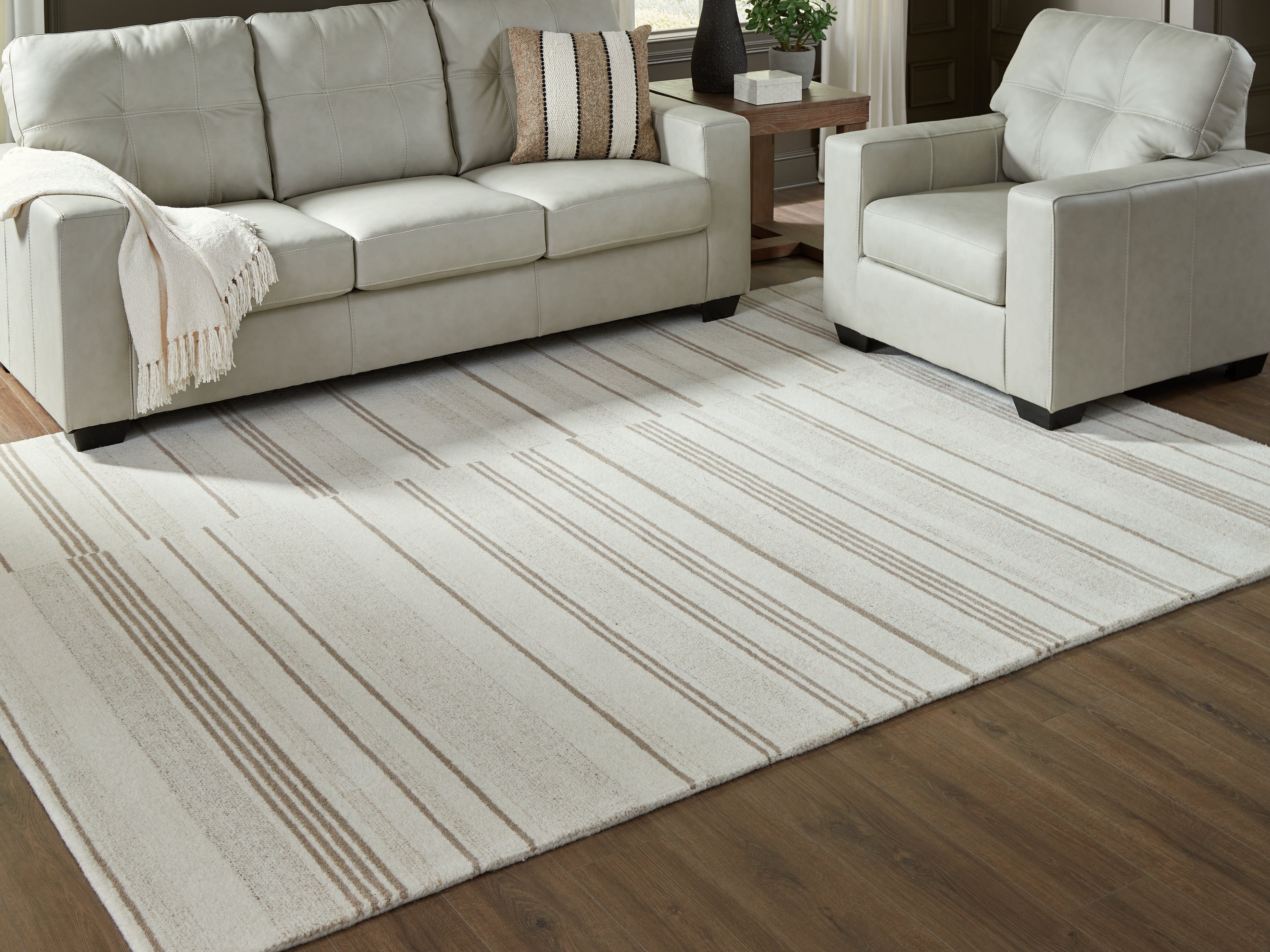 Fine Furniture & Decor - Ashley Furniture - Gadence Rug - 7'8" x 10' Area Rug / Ivory/Tan - R407641